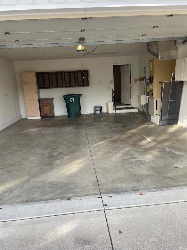 garage featuring heating unit and a garage door opener