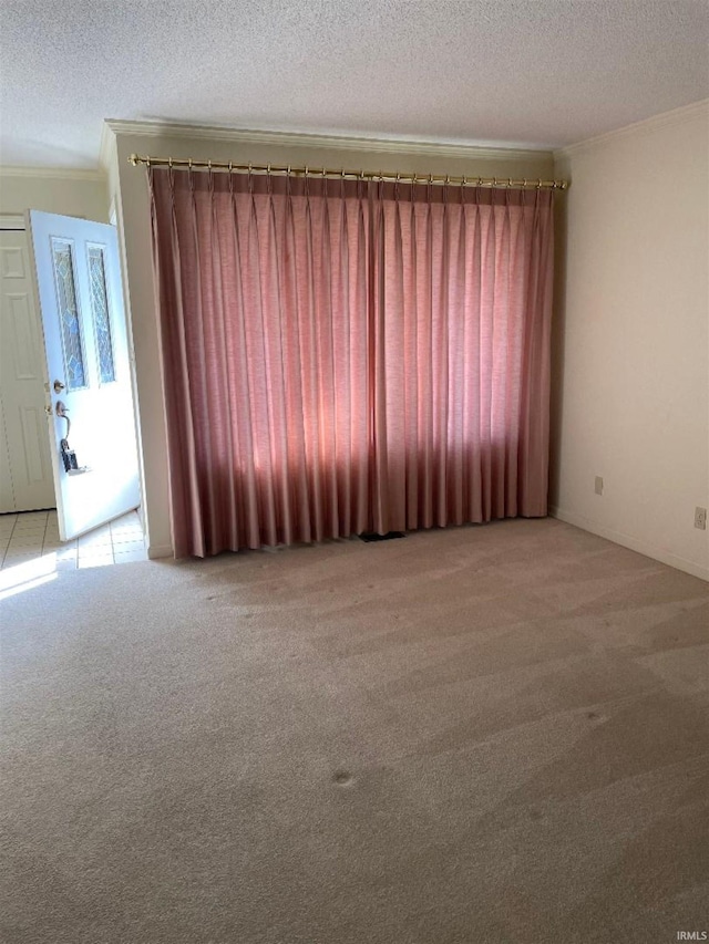 carpeted empty room with a textured ceiling