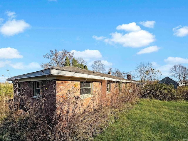 view of home's exterior with a lawn