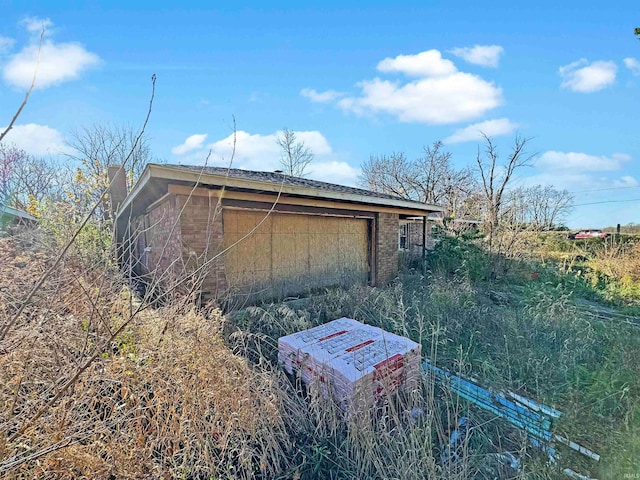 view of property exterior with an outdoor structure