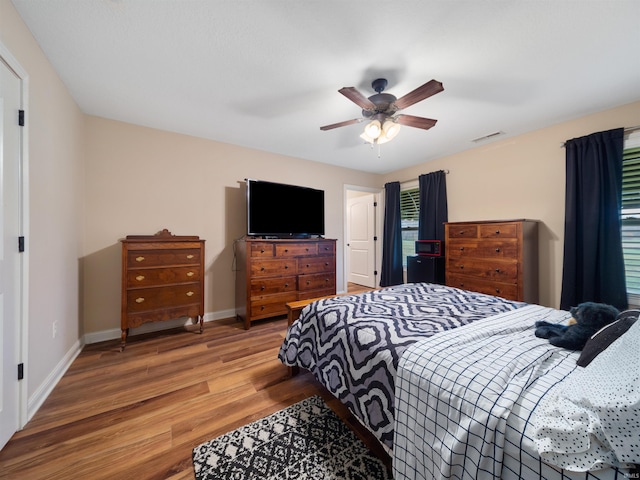 bedroom with hardwood / wood-style floors and ceiling fan