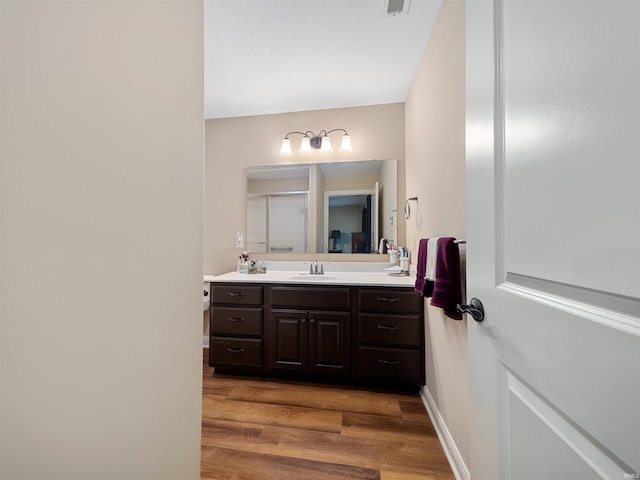 bathroom featuring vanity and hardwood / wood-style floors