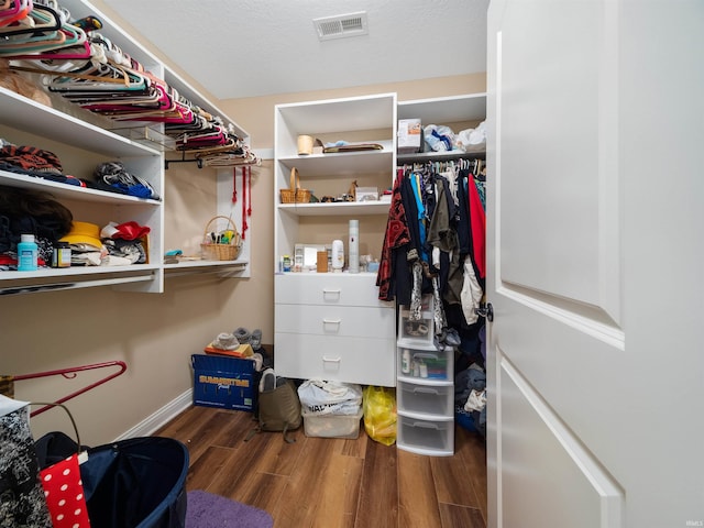 walk in closet featuring dark hardwood / wood-style floors