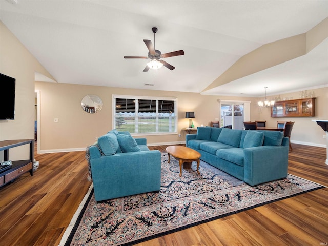 living room featuring ceiling fan with notable chandelier, lofted ceiling, and dark hardwood / wood-style floors