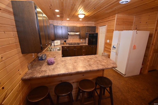 0 N 15e Rd, Jasper, IN 47546 - kitchen featuring black appliances, a peninsula, light countertops, wooden ceiling, and wood walls