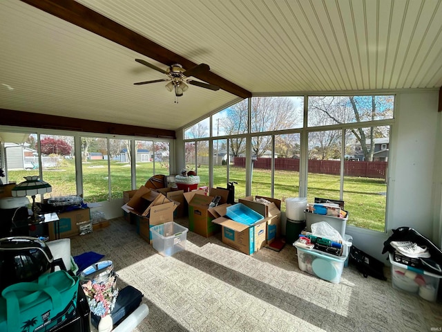 sunroom featuring vaulted ceiling with beams and ceiling fan