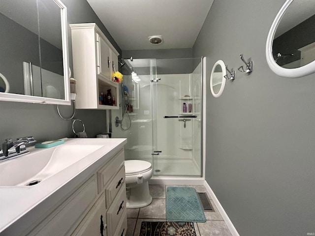 bathroom with vanity, a shower with shower door, tile patterned floors, and toilet