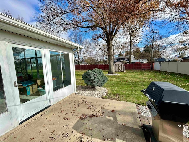 view of yard with a storage shed and a patio area