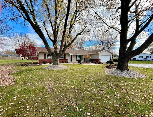 single story home featuring a garage and a front yard