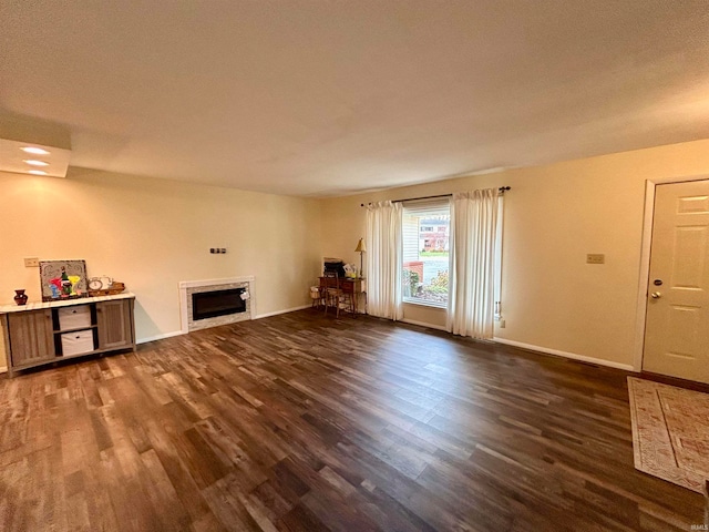 unfurnished living room with dark wood-type flooring