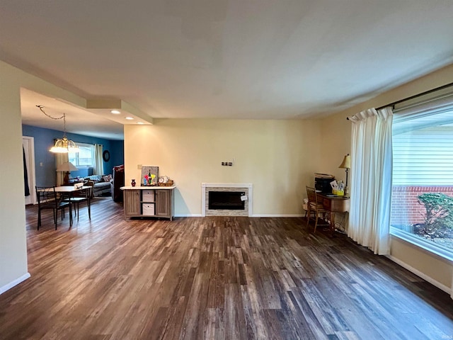 living room with dark hardwood / wood-style floors and a notable chandelier