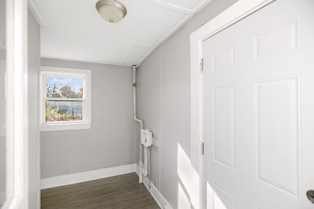 corridor with dark hardwood / wood-style flooring