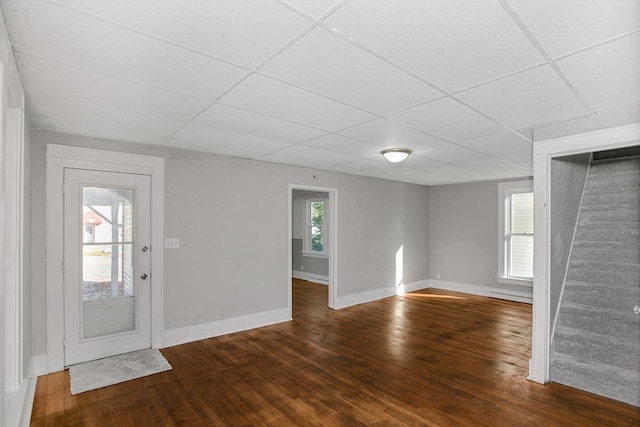 foyer featuring a drop ceiling, dark hardwood / wood-style floors, and plenty of natural light