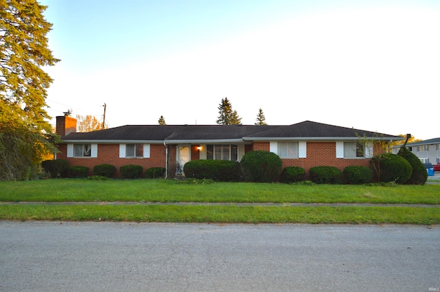 ranch-style house with a front lawn