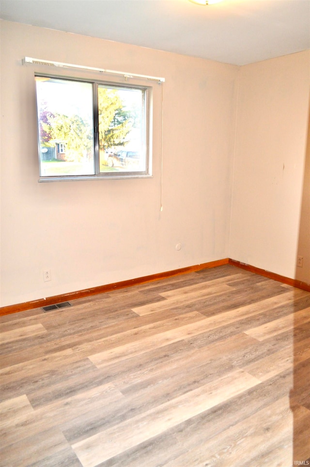 spare room with light hardwood / wood-style flooring