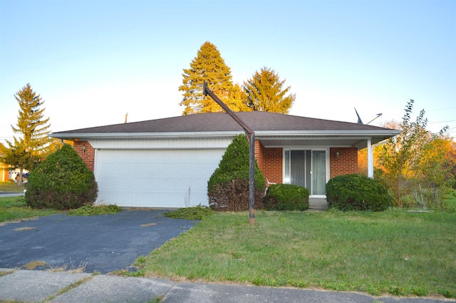 single story home featuring a garage and a front yard