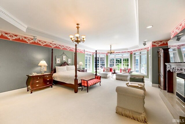 carpeted bedroom with a tiled fireplace, a notable chandelier, and ornamental molding