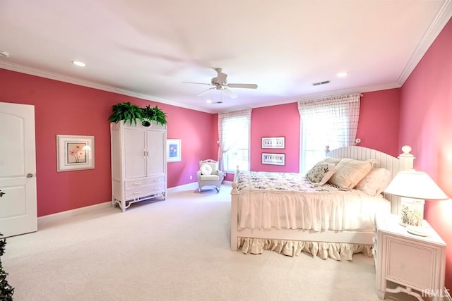 carpeted bedroom featuring ceiling fan and crown molding