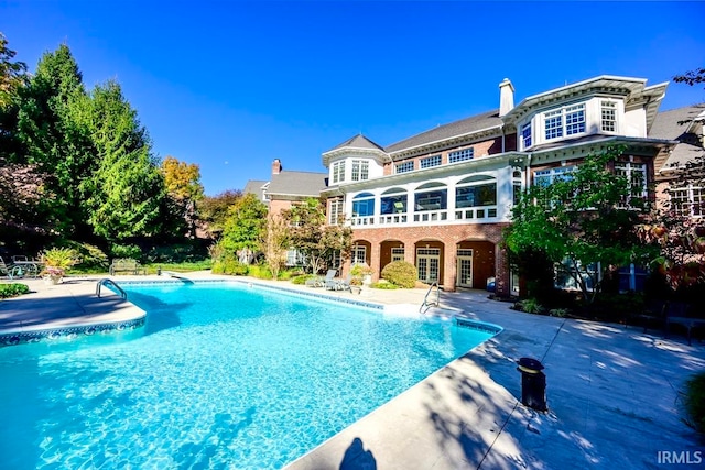 view of swimming pool with a patio