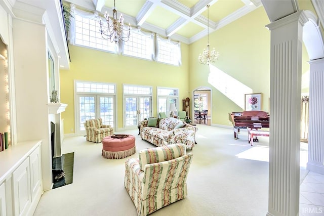 carpeted living room with plenty of natural light, beam ceiling, decorative columns, and coffered ceiling