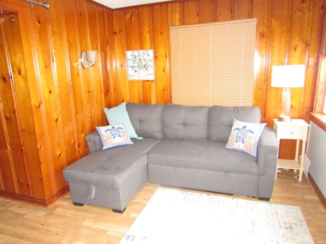 living room with wood walls and light wood-type flooring