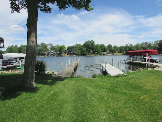 view of dock featuring a yard and a water view