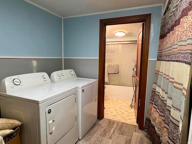 clothes washing area featuring separate washer and dryer and crown molding