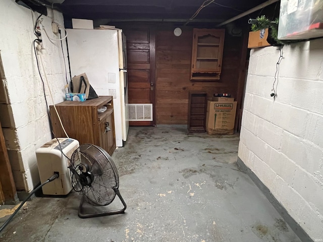 basement with white fridge