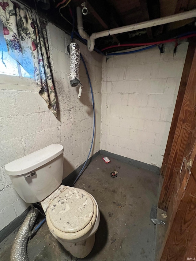 bathroom featuring concrete floors and toilet