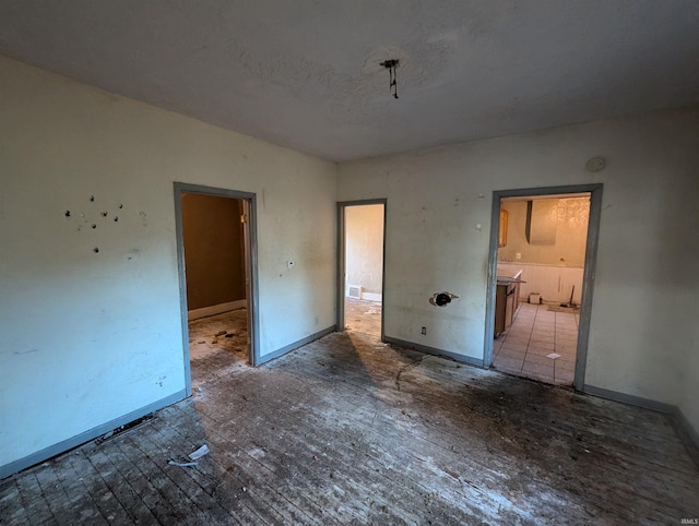 unfurnished bedroom with connected bathroom and a textured ceiling