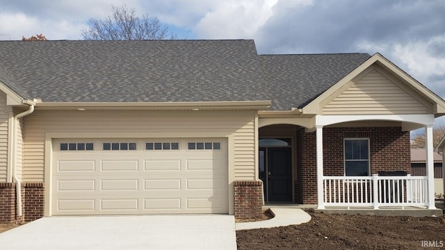 single story home featuring a garage and a porch