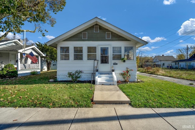 bungalow-style home featuring a front yard