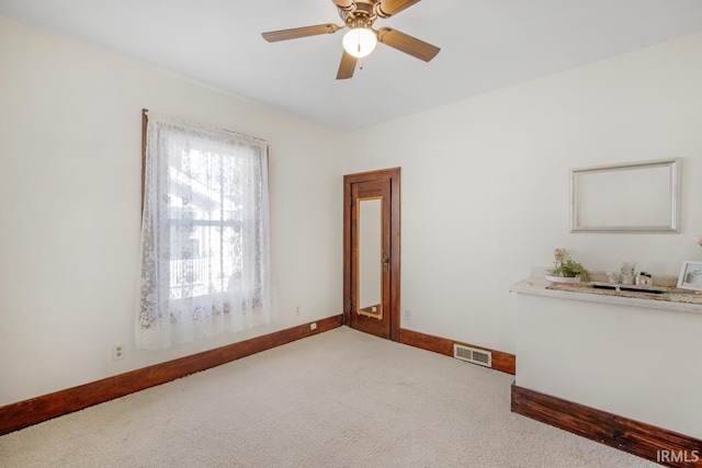 spare room with ceiling fan and carpet flooring