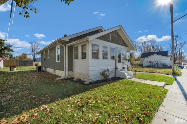 view of front facade with central AC unit and a front lawn