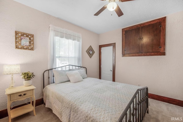 bedroom featuring light carpet and ceiling fan