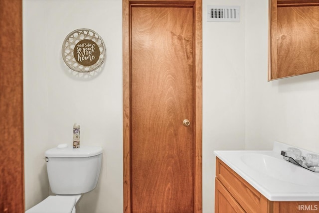 bathroom featuring toilet and vanity