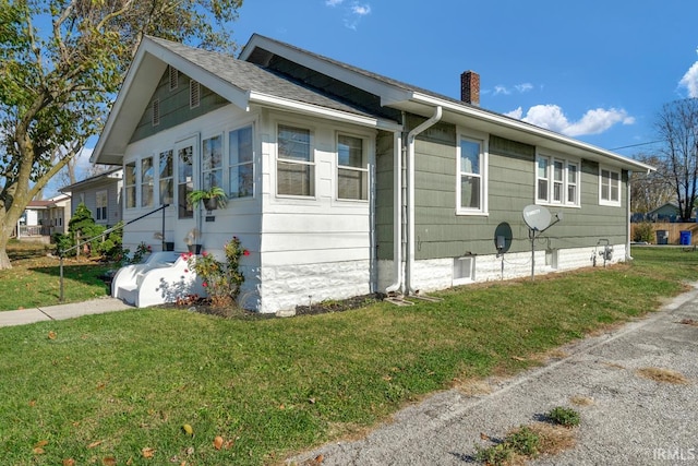 view of side of home featuring a yard