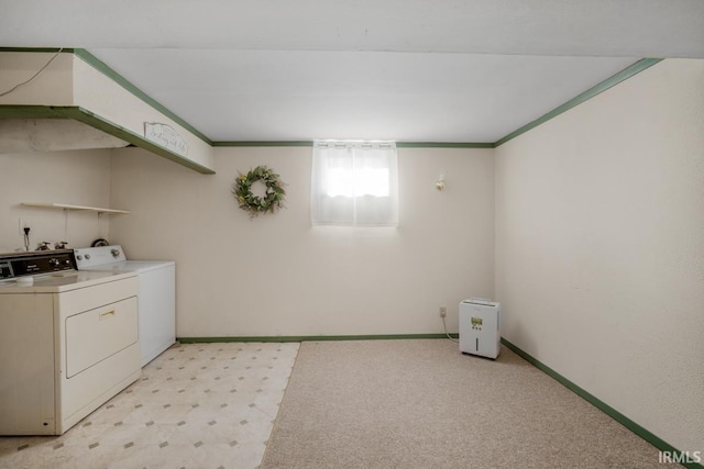 clothes washing area with independent washer and dryer, light colored carpet, and crown molding