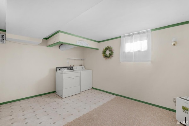 washroom featuring washing machine and clothes dryer and light colored carpet