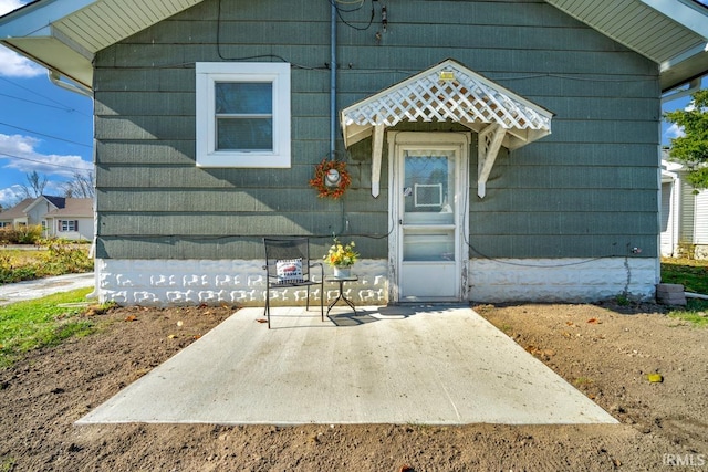 property entrance featuring a patio