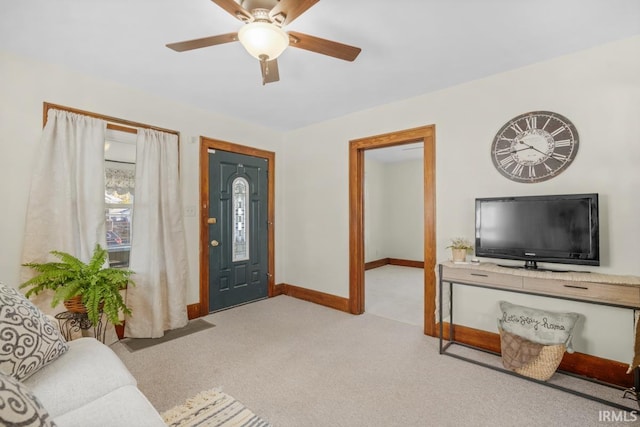 entryway featuring light carpet and ceiling fan