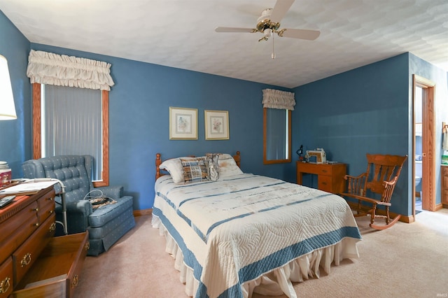 carpeted bedroom with multiple windows and ceiling fan