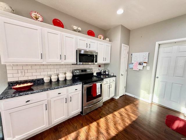 kitchen featuring white cabinets, decorative backsplash, dark hardwood / wood-style floors, and stainless steel appliances