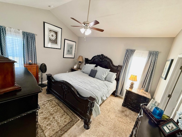 carpeted bedroom with lofted ceiling, multiple windows, and ceiling fan