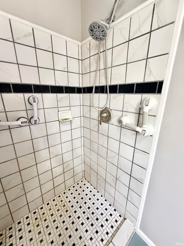 bathroom with tiled shower