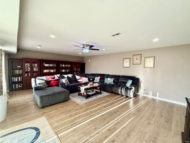 living room with ceiling fan and light hardwood / wood-style floors