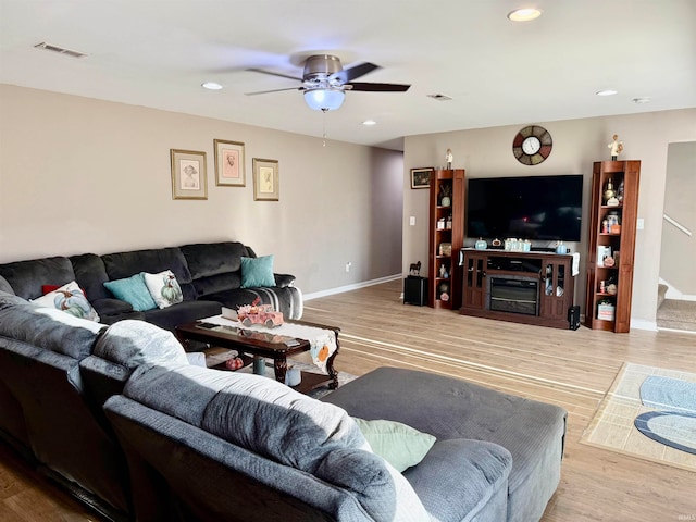 living room with ceiling fan and light hardwood / wood-style flooring