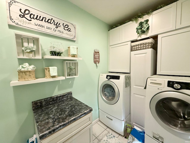 clothes washing area featuring cabinets and independent washer and dryer