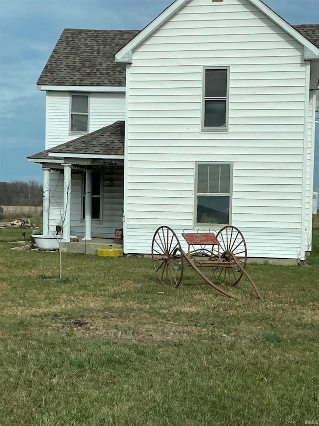 rear view of property with a yard