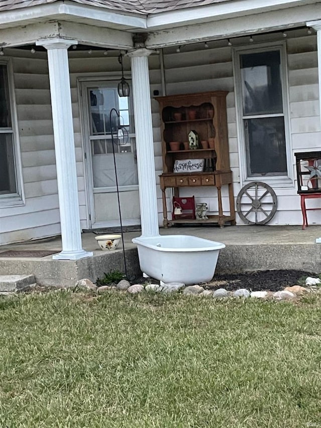 view of exterior entry featuring a yard